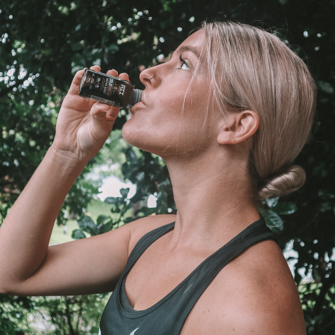 man drinking a cold brew coffee shot