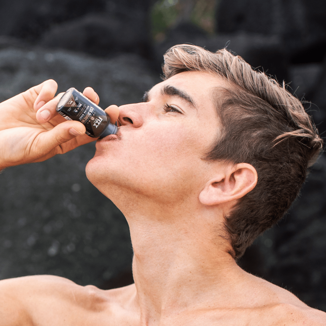 man drinking a cold brew coffee shot